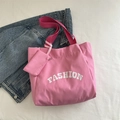 Großes Set aus modischer Tragetasche in Pink mit weißem FASHION-Aufdruck und Beutel - Rosa