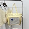 Pale yellow nylon tote bag with clear front pocket and adjustable shoulder strap - Yellow