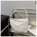 Close-up of white bucket bag with pretty and libety embroidery on minimal shelf - White