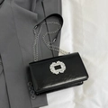 Black leather crossbody bag with a large crystal buckle and silver chain strap - Black