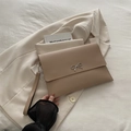 Minimalist khaki envelope clutch bag with silver bow accent and detachable wrist strap - Khaki