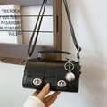 Glossy black eel-pattern crossbody bag with silver twist locks and metallic charm - Black With Rabbit Pendant