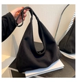 Detail of matte suede tote bag with magnetic snap closure and seamless shoulder strap - Black