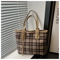 Detalle de bolso tote de lona a cuadros con correas de cuero en un ambiente minimalista - Caqui