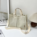 Minimalist beige corduroy tote bag with dual front pockets and adjustable shoulder strap - Off White