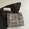 Retro striped tote bag with jacquard fabric and brown leather handles in a stylish 45-degree view - Coffee without Charm