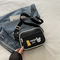 Black quilted crossbody bag with cartoon bunny print and white contrast piping detail - Black