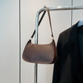 Retro dark brown baguette bag with Saffiano texture and gold hardware on silver stand - Brown