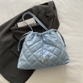 Quilted sky blue drawstring tote bag with metallic bow detail and glossy finish - Blue