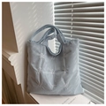 Close-up of light blue corduroy tote bag showing high-quality letter embroidery detail - Blue