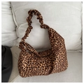 Detail of leopard print tote bag featuring a gathered elastic strap and metal zipper closure - Brown