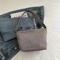 Minimalist grey-purple hobo bucket bag with ruched texture on blue denim jacket - Gray
