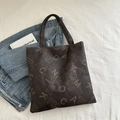 Dark brown tote bag with beige letter prints and high-texture synthetic leather finish - Brown
