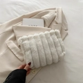 Chic white faux fur handbag with vertical stripes on a beige blazer background - White