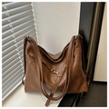 Detailed view of large brown retro tote bag with dual straps and brass metal hardware - Brown