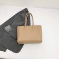 Minimalist khaki PU leather tote bag for women with long handles in a flat lay view - Khaki