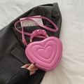 Pink heart-shaped handbag with pleated handle and concentric circle stitching detail - Pink