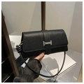 Detail of black crocodile texture bag featuring a silver rectangular metal buckle clasp - Black