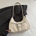 Chic cream-colored underarm bag with silver buckle and dual zipper on grey blazer - White