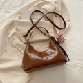 Retro brown oil wax leather dumpling bag with glossy finish and bear charm accessory - Brown with Charm