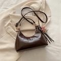 Brown oil wax leather hobo bag with a plush bear charm on a beige blazer background - Coffee with Charm