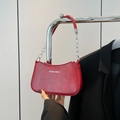 Deep red crescent underarm bag featuring a textured finish and metal chain handle - Red
