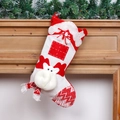 Red and white knitted Christmas stocking decoration with reindeer antlers on a mantel - Elk Style