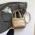 Golden quilted puffer bucket bag with woven shoulder strap and metallic finish - Gold