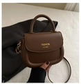 Detail view of dark brown retro leather handbag with gold metal hardware and brand logo - Brown