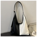 Detail view of the black and white color-block hobo bag with adjustable PU leather strap - White