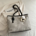 Grey textured tote bag with black straps and white plush pendant for daily commute - With Pendant / Gray