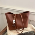 Minimalist dark brown tote bag with fuzzy charm on a beige blanket for daily commute - With Pendant / Tan