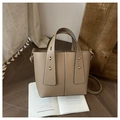 Close-up of khaki bucket bag with lychee texture, gold rivets and stitching details - Khaki