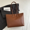 Minimalist large brown leather tote bag with V-shaped stitching on light fabric background - Yellow Brown No Pendant