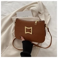 Detail of caramel quilted crossbody bag with gold hardware and rhombic stitching texture - Brown