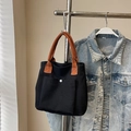 Minimalist black canvas tote bag with contrast orange handles and a snap button pocket - Black