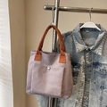Minimalist light purple canvas handbag with orange handles and front metal button pocket - Gray