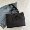 Minimalist black tote bag in nylon with decorative ropes and functional side pockets - Black