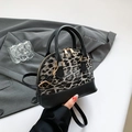 Classic leopard print shell bag with black leather trim and elegant gold hardware - Black