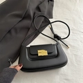Minimalist black faux leather saddle bag with unique gold chocolate bite metal buckle - Black