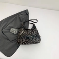 Schicke Hobo-Schultertasche mit Leopardenmuster und goldener Hardware auf weißem Grund - Braun