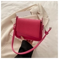 Detail of magenta shoulder bag featuring woven flap texture and knotted cord strap - Rose Pink