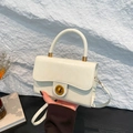 White faux leather top handle bag with gold round twist lock and thin shoulder strap - White