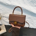 Retro dark brown leather crossbody bag with round handle and gold metal twist lock - Brown