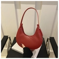 Detail of red croc-embossed hobo bag showing texture and metal buckle on side strap - Red