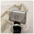 Close-up of a silver chain bag with a sparkling rhinestone buckle and metallic finish - Silver