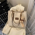 Chic cream tote bag with brown leather straps and cute bear charm in a shopping cart - With Pendant / Brown