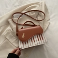 Brown and white crossbody bag with piano key design and golden musical note charm - Brown