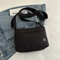 Minimalist black nylon crossbody bag with adjustable wide strap and silver metal flower logo - Black