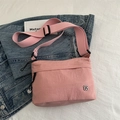 Pink waterproof nylon crossbody bag with adjustable strap and small petal logo - Pink